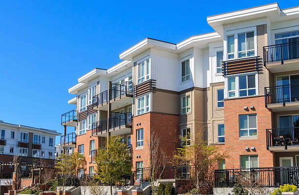 4-story apartment building with modern brick facade and trees out front 